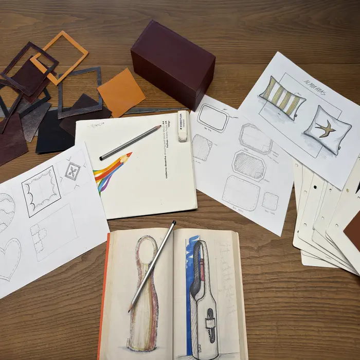Wooden table with drawings of products on paper
