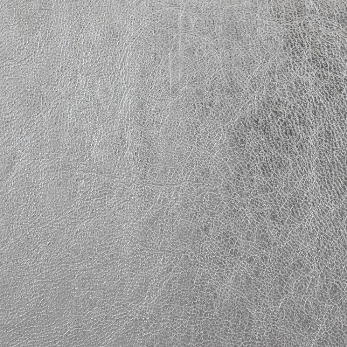 White leather with some darker spots, a very defined pattern and a glossy metallic finish